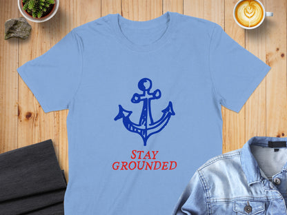 Blue t-shirt with a red anchor and "STAY GROUNDED" text.
