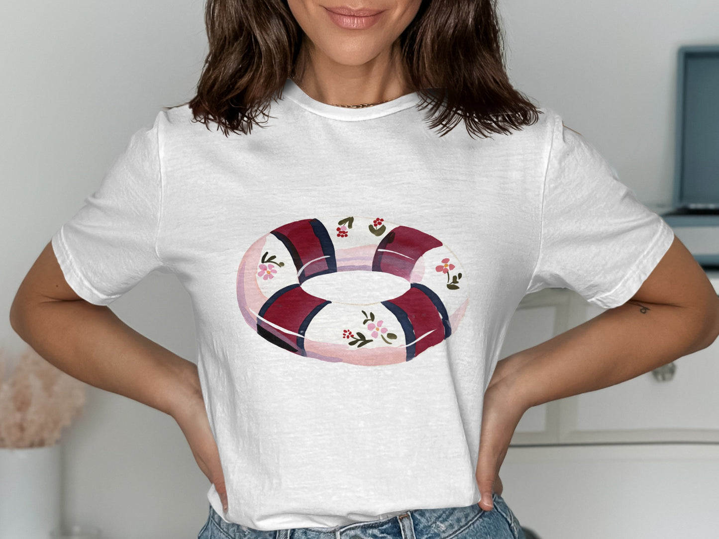 White t-shirt with a watercolor-style life preserver graphic.