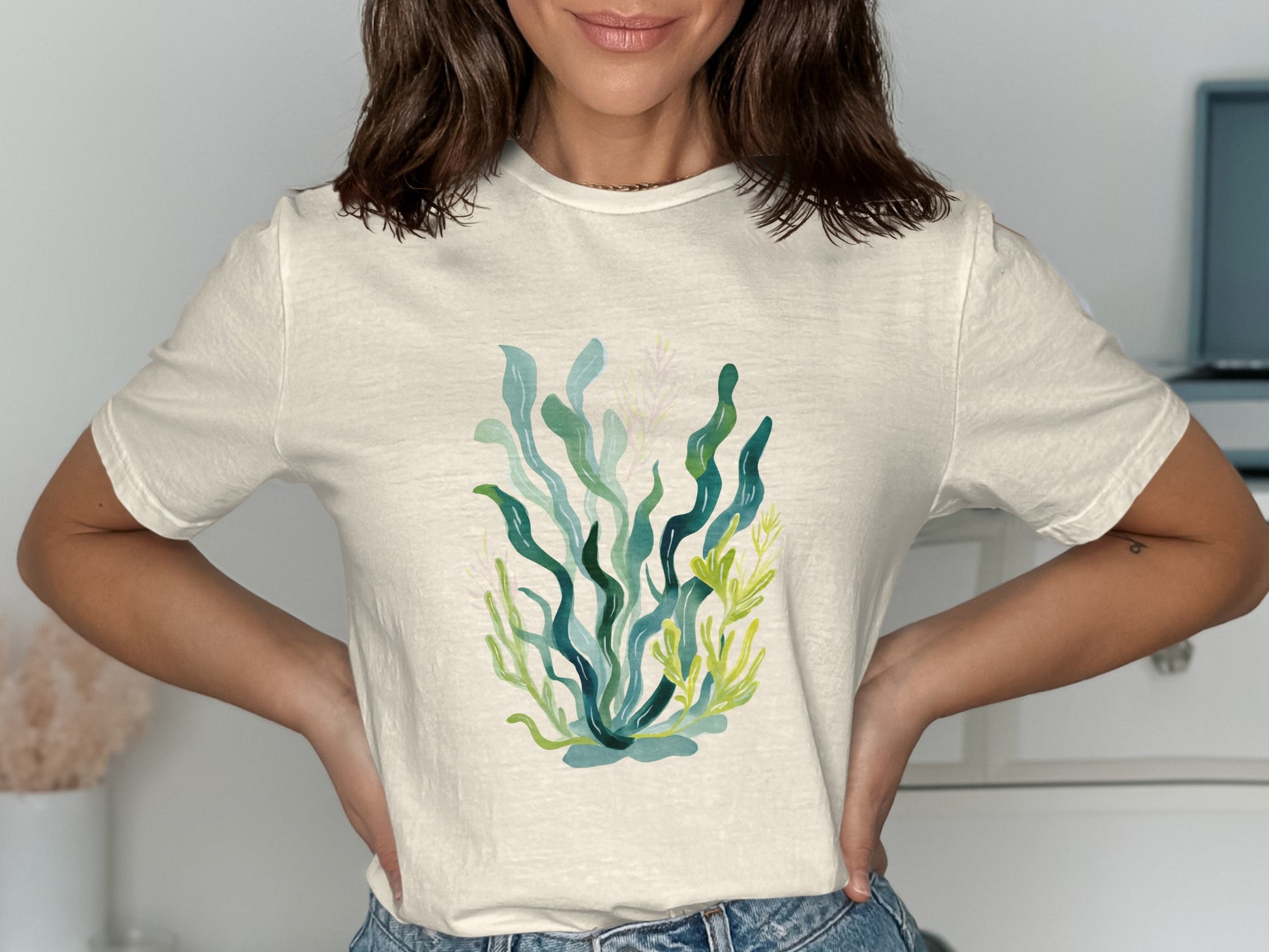 Cream t-shirt with abstract watercolor seaweed and coral design.