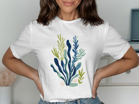 White t-shirt with a blue and green abstract botanical print.