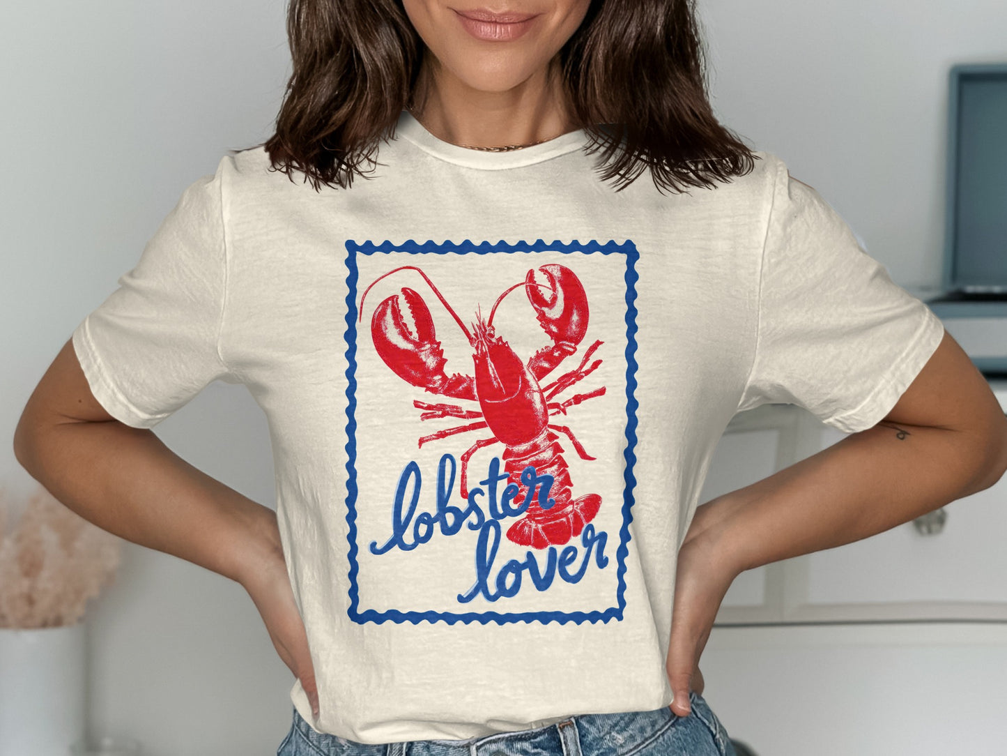 Cream t-shirt with red lobster and "lobster lover" text in blue border.