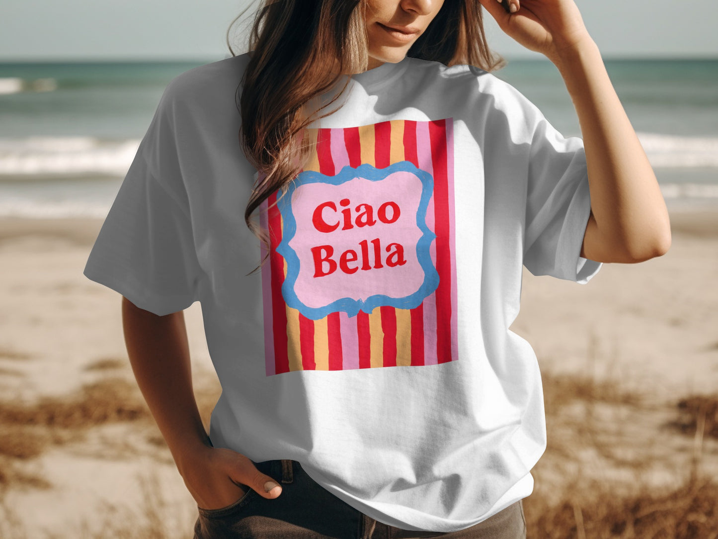White t-shirt with "Ciao Bella" text on a striped pink and yellow background.