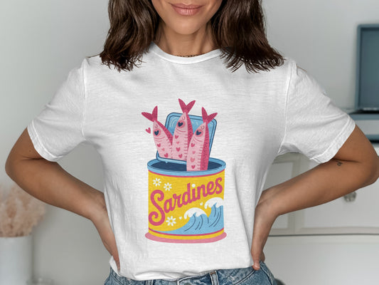 White t-shirt with a graphic of sardines in an open can and waves.
