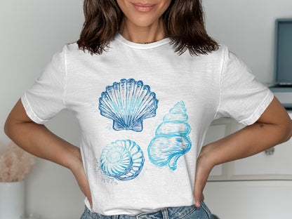 White t-shirt with three blue watercolor seashell illustrations.