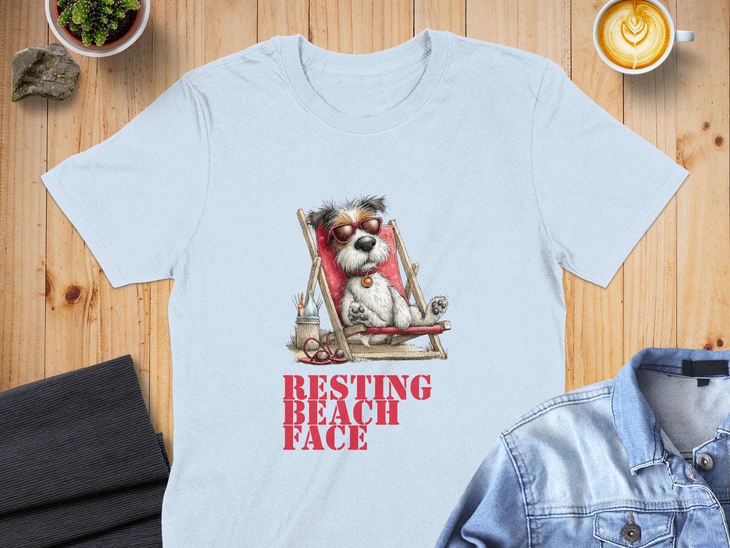 Light blue t-shirt with dog in sunglasses on beach chair, "RESTING BEACH FACE" text.
