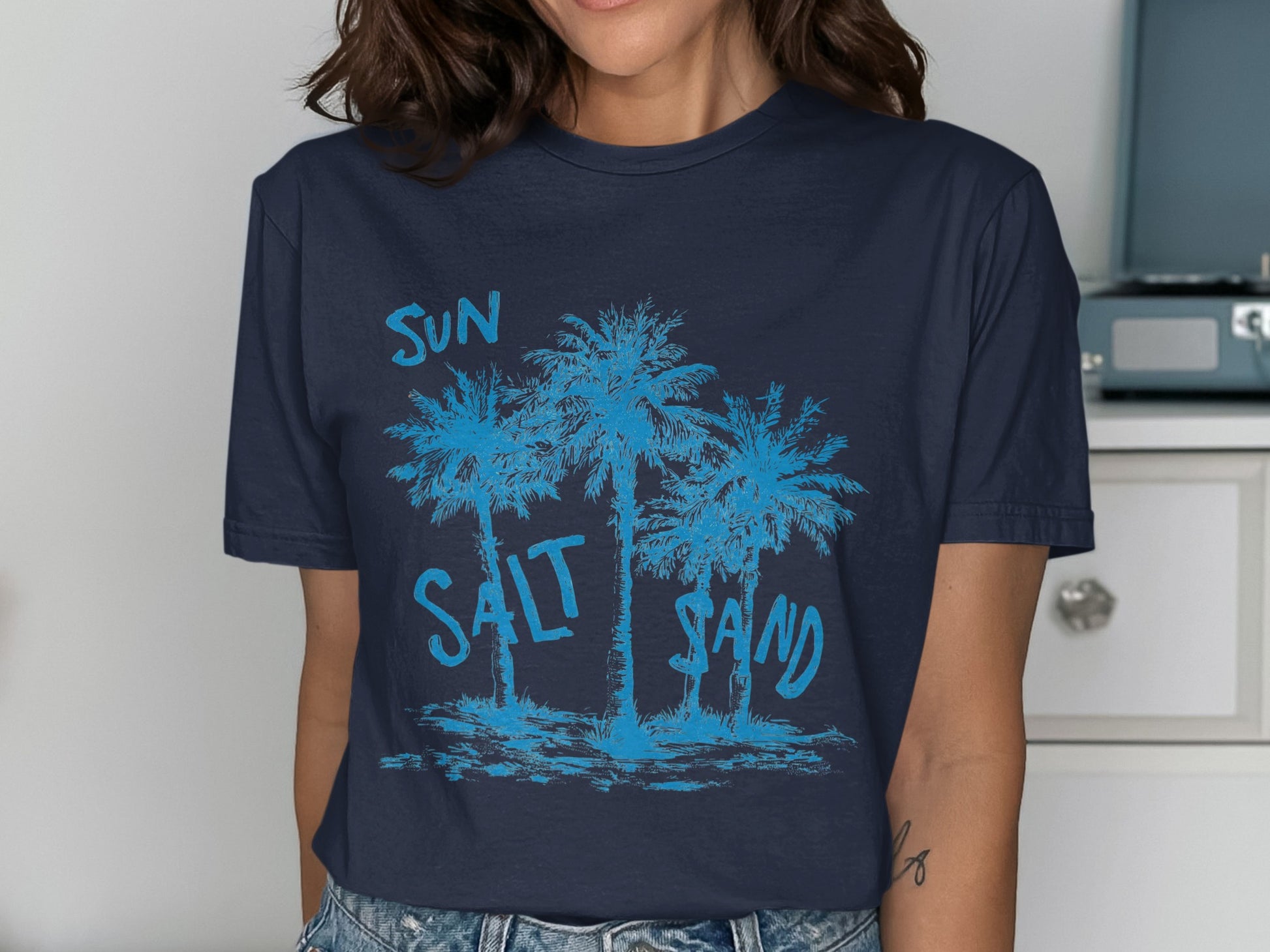 Navy t-shirt with blue palm trees and text "SUN SALT SAND".