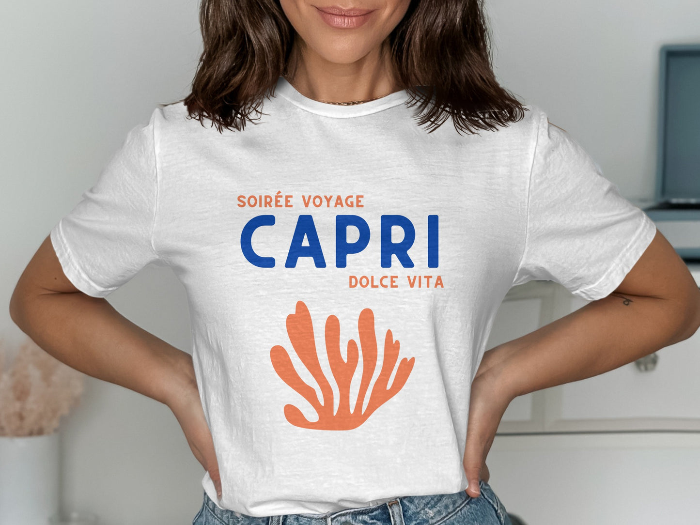 White t-shirt with "Soirée Voyage Capri Dolce Vita" text and orange coral graphic.
