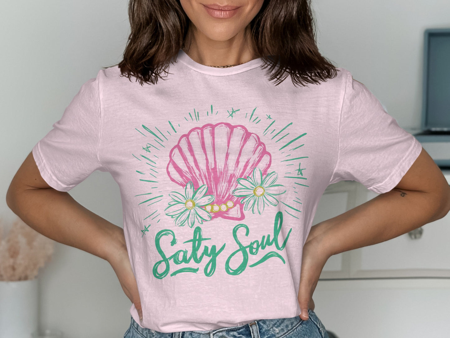 Light pink t-shirt with a pink seashell and flowers graphic and text "Salty Soul".