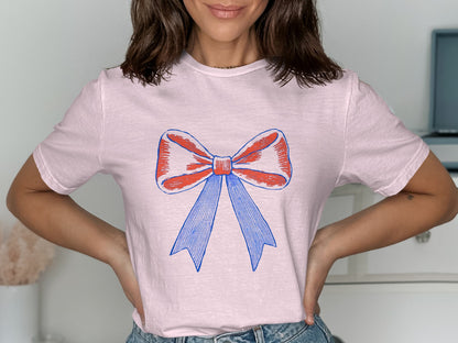 Stylish Pink T-Shirt with Blue and Red Bow Design product
