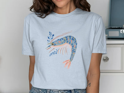 Light blue t-shirt with a colorful shrimp and floral design.