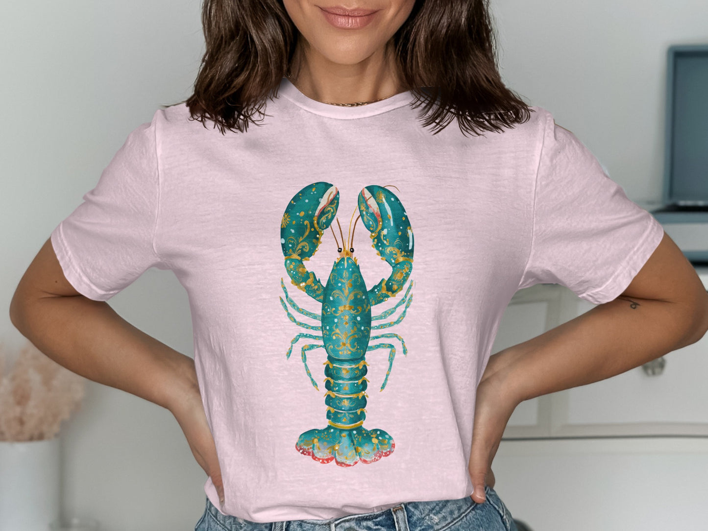 Light pink t-shirt with a decorative teal and gold lobster graphic.