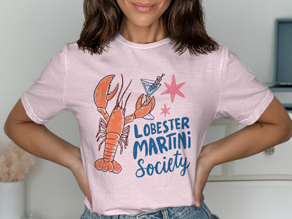 Pink t-shirt with a lobster and martini glass graphic and "Lobster Martini Society" text.