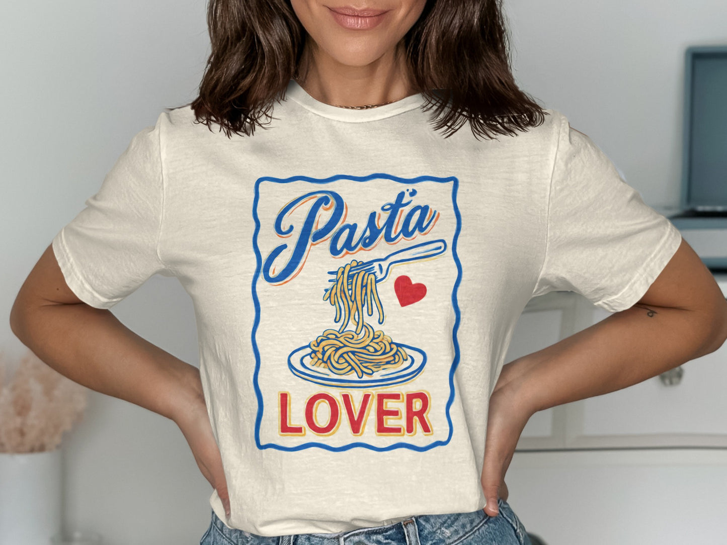 Cream t-shirt with "Pasta Lover" and pasta on a fork.