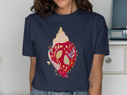 Navy t-shirt with a watercolor seashell and floral design.