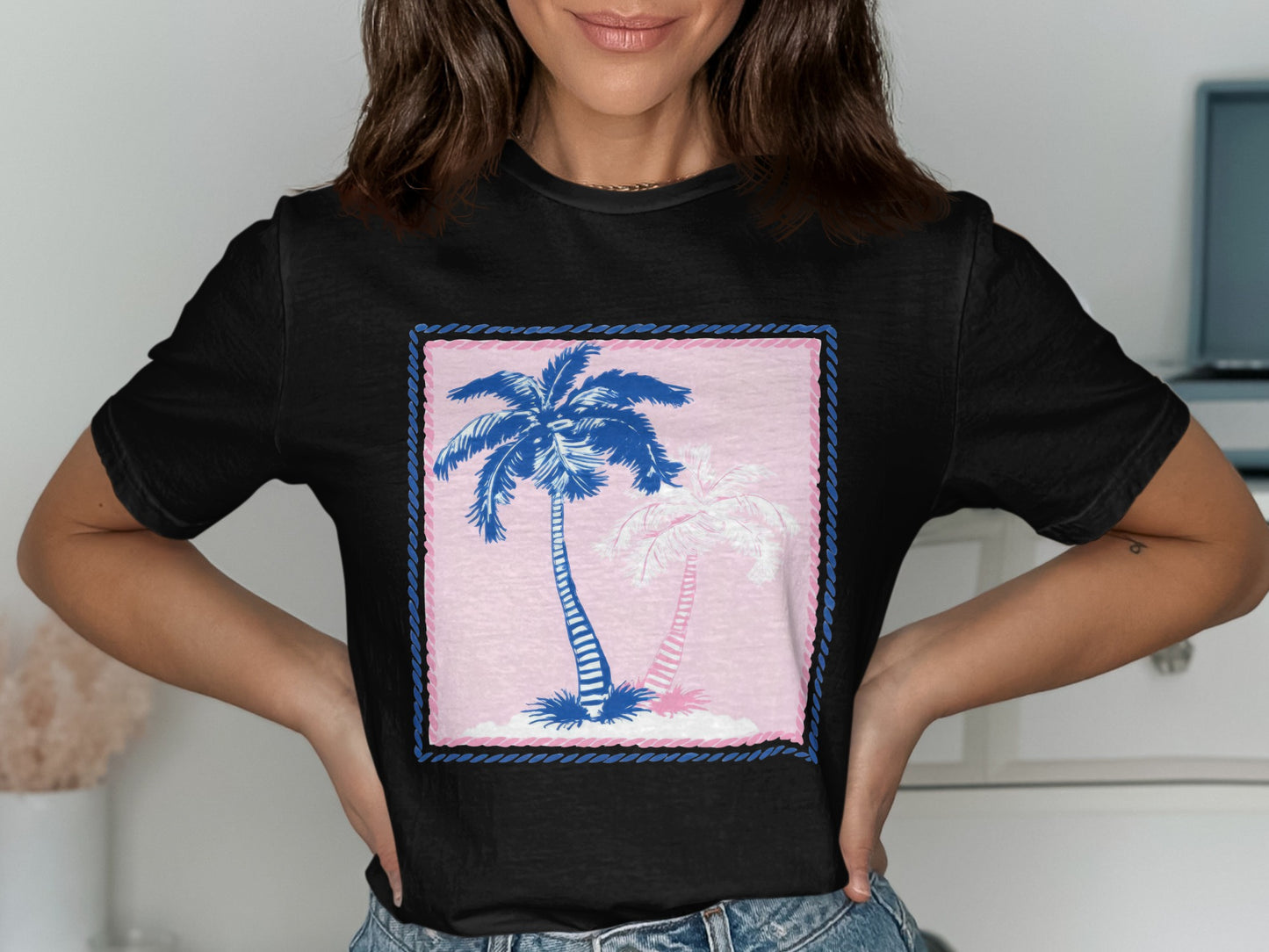 Black t-shirt with two palm trees on an island graphic.