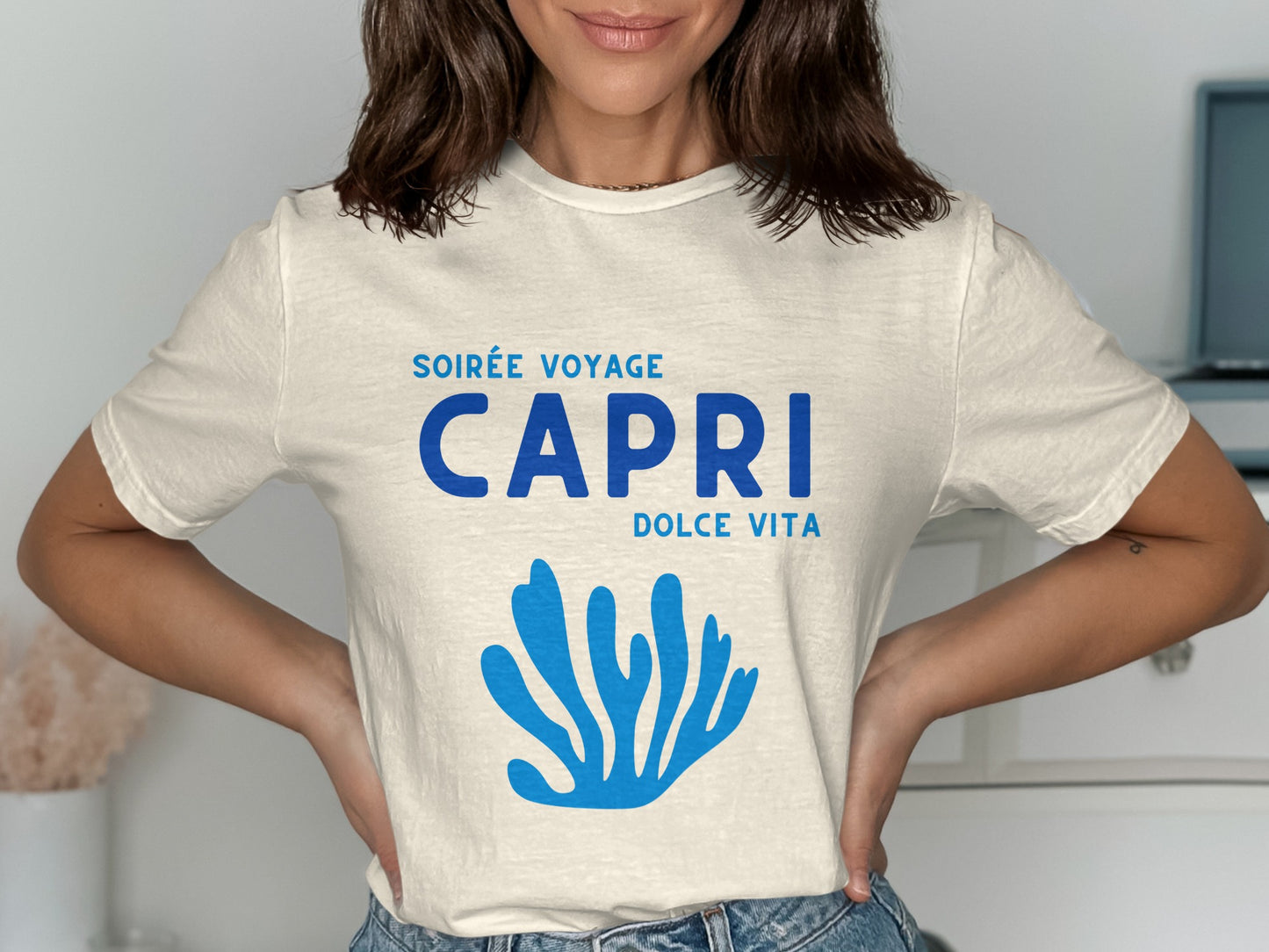 Cream t-shirt with "SOIRÉE VOYAGE CAPRI DOLCE VITA" text and blue coral graphic.