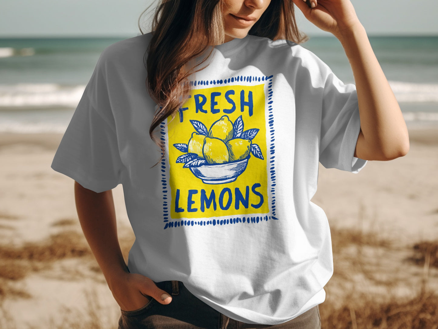 White t-shirt with yellow lemons in a blue bowl graphic and "FRESH LEMONS" text.