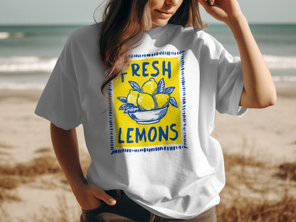 White t-shirt with yellow lemons in a blue bowl graphic and "FRESH LEMONS" text.