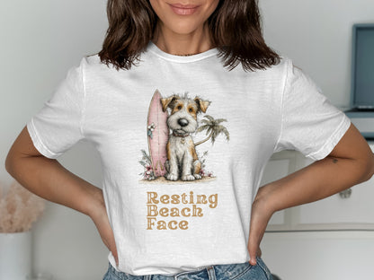 Dog with surfboard and palm tree on white t-shirt with text "Resting Beach Face".