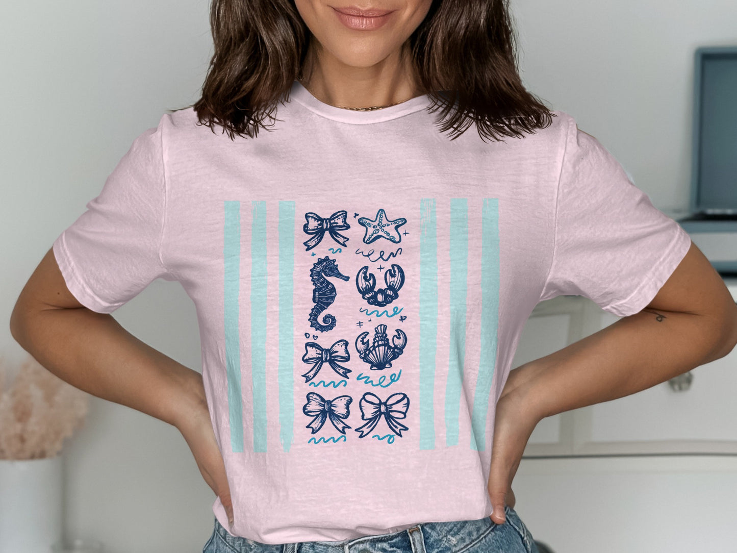 Light pink t-shirt with blue nautical illustrations in columns.