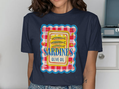 Dark blue t-shirt with a colorful label featuring sardines in olive oil.