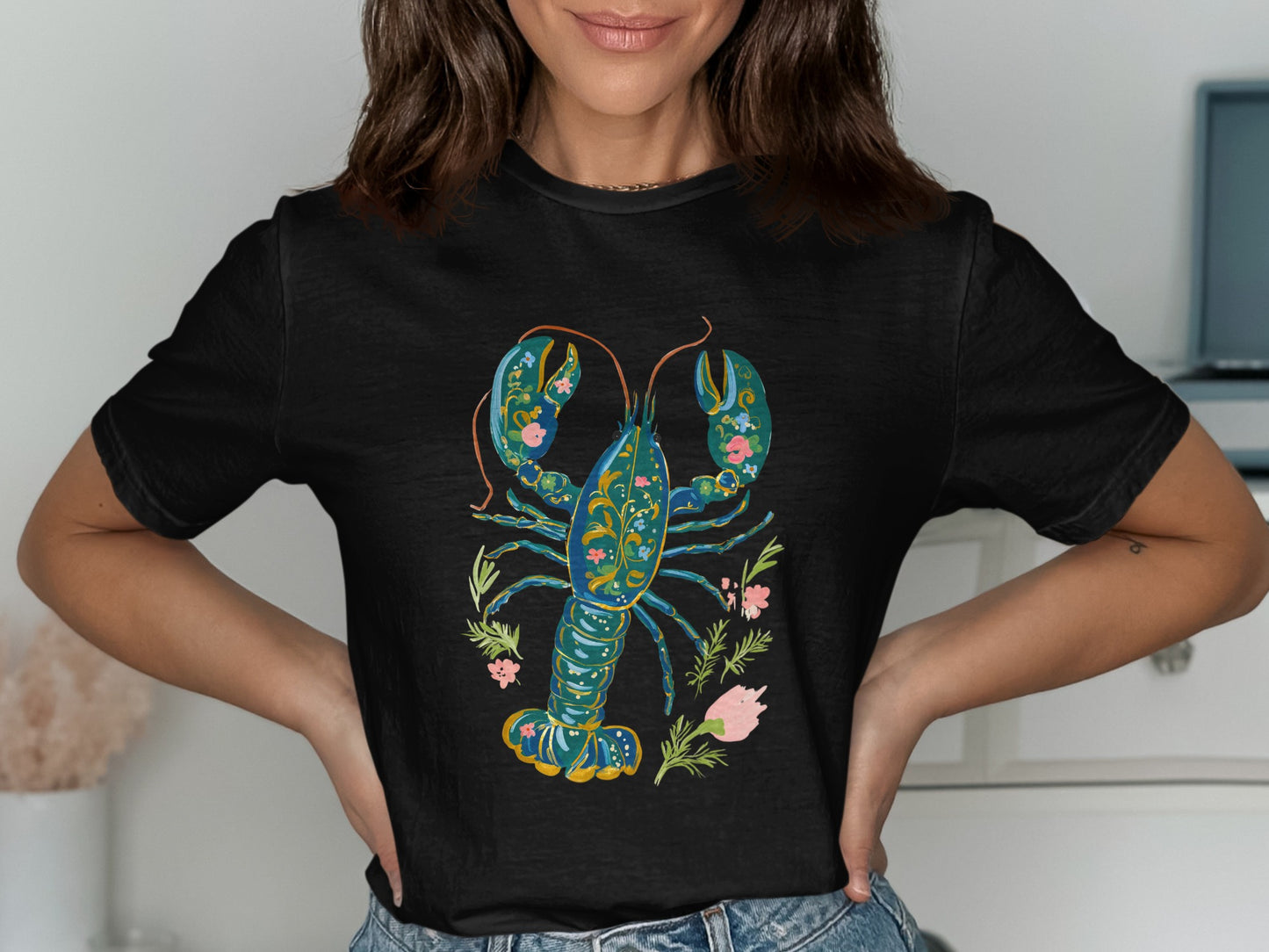 Black t-shirt with a stylized blue and green lobster and floral design.