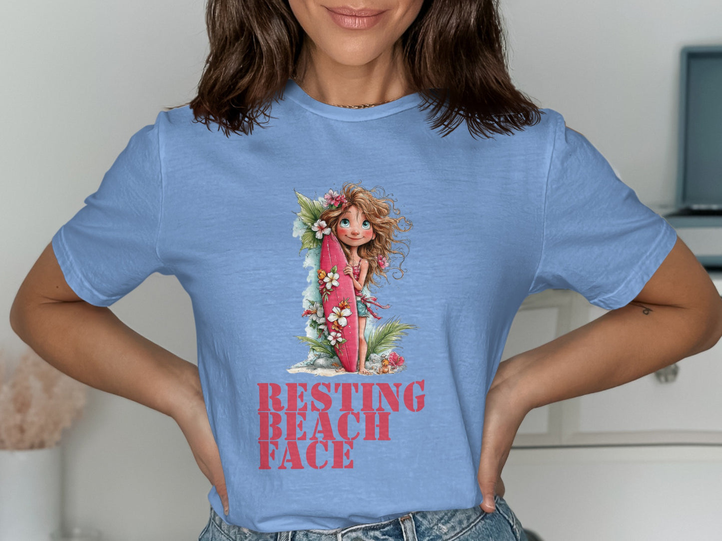 Light blue t-shirt featuring a girl with a surfboard and "Resting Beach Face" text.