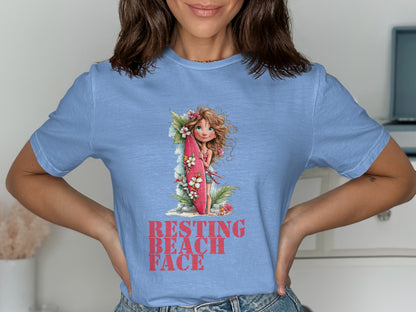 Light blue t-shirt featuring a girl with a surfboard and "Resting Beach Face" text.