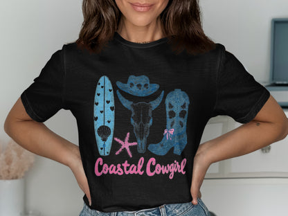Black t-shirt with surfboards, cow skull, boots, and starfish, "Coastal Cowgirl" text.