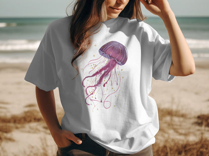 White t-shirt with a purple watercolor jellyfish graphic and gold accents.