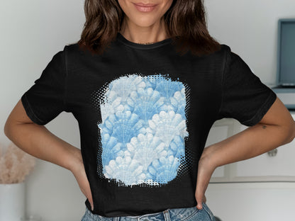 Black t-shirt featuring a watercolor seashell pattern in shades of blue.