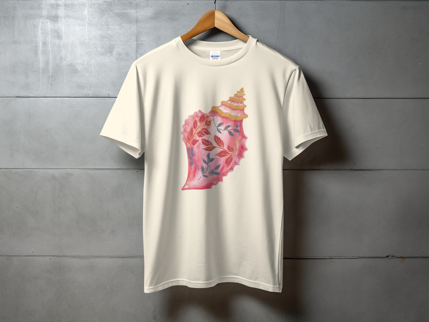 Beige t-shirt with a pink seashell and floral design.