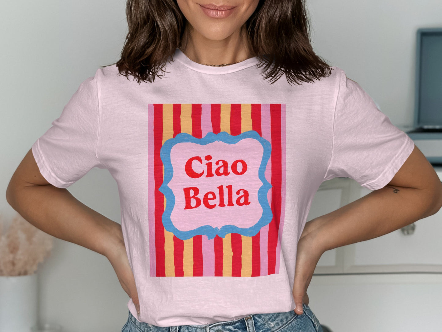 Pink t-shirt with "Ciao Bella" text on a striped background.