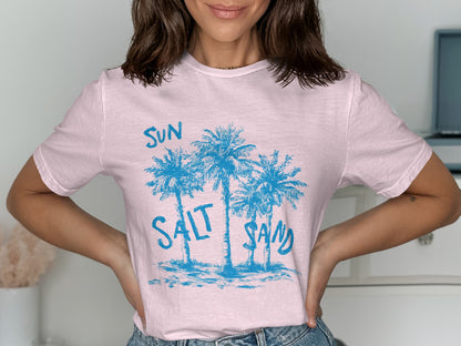 Light pink t-shirt with blue palm trees and "SUN SALT SAND" text.