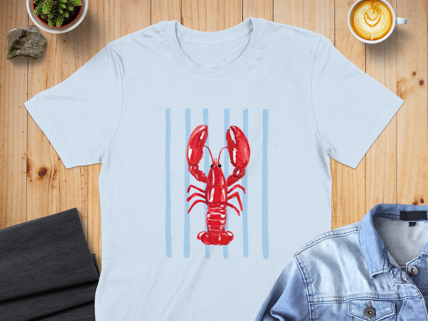 Light blue t-shirt with a watercolor red lobster and blue stripes.