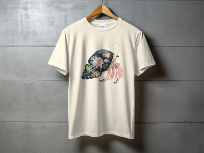 Cream t-shirt with a watercolor hermit crab and floral design.