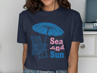 Navy t-shirt with blue umbrella, beach chair, and "Sea and Sun" text.