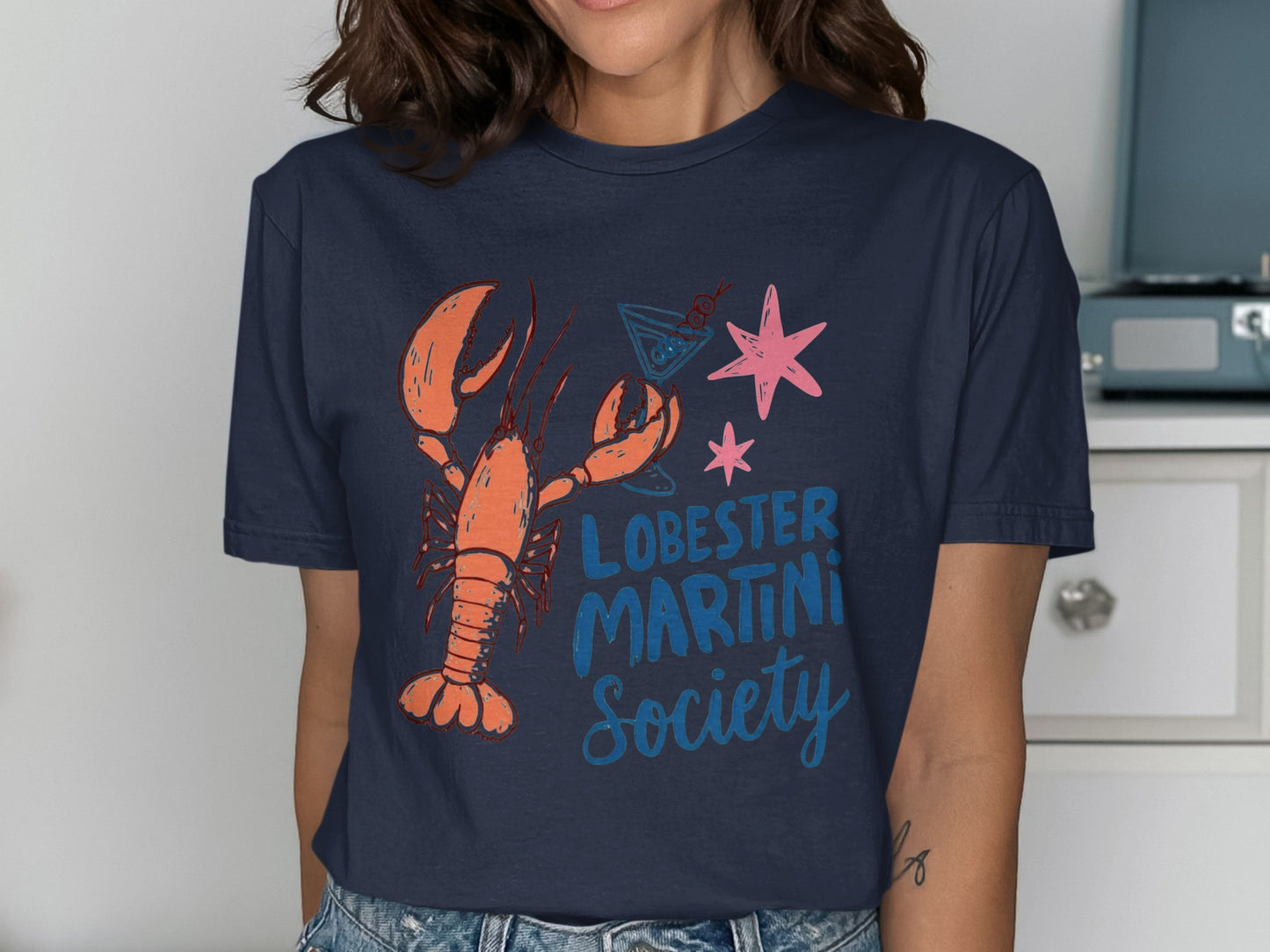 Lobster Martini Society t-shirt with orange lobster, martini glass, and pink star.