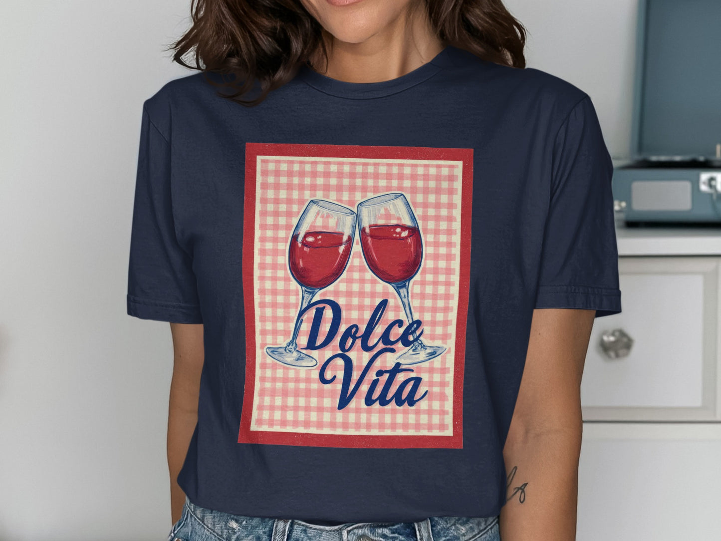 Two wine glasses clinking with "Dolce Vita" text on a gingham background.