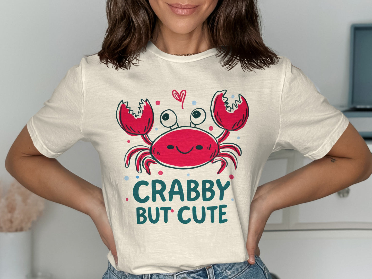 Cream t-shirt with a smiling crab graphic and text "CRABBY BUT CUTE".