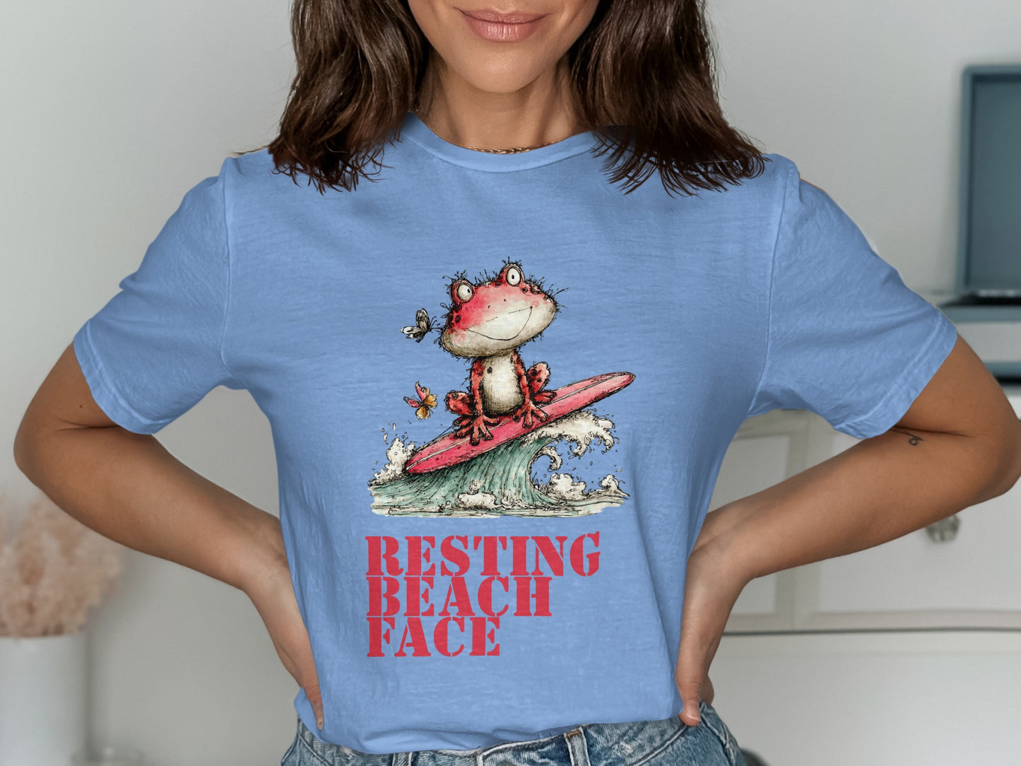 Frog in sunglasses surfing a wave with butterfly, "RESTING BEACH FACE" text.