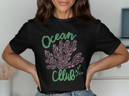 Black t-shirt with green and pink coral graphic and "Ocean Club" text.