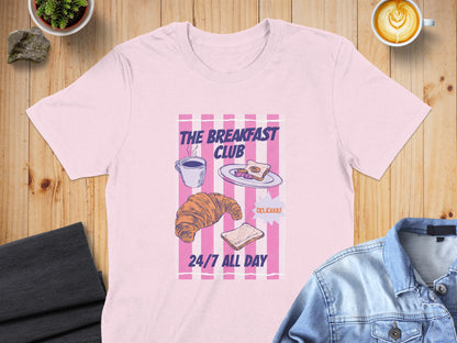 Pink t-shirt with "The Breakfast Club" logo, croissant, and toast illustration.