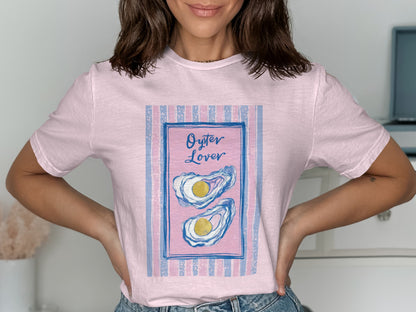 Pink t-shirt with a framed illustration of two oysters and "Oyster Lover" text.