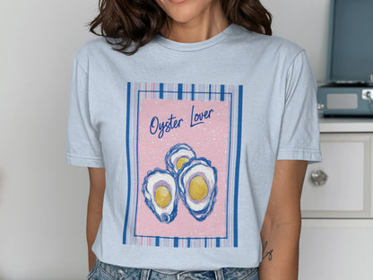 Light blue t-shirt with graphic of three oysters and text "Oyster Lover".