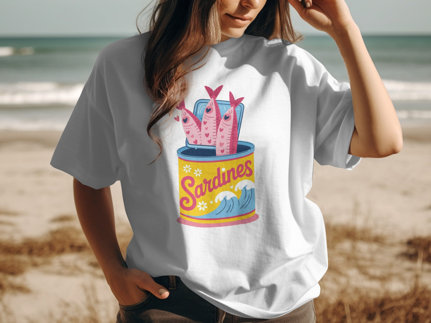 Cartoon sardines in a can with waves and stars on a white t-shirt.