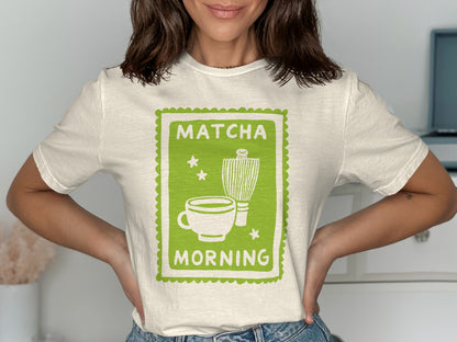 Cream t-shirt with green graphic of matcha cup, whisk, and text "MATCHA MORNING".