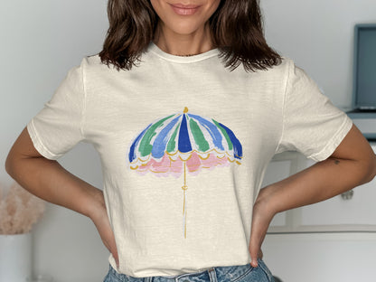 Cream t-shirt with a watercolor-style beach umbrella graphic.