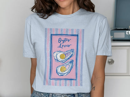 Light blue t-shirt with pink and blue striped background and "Oyster Lover" text.