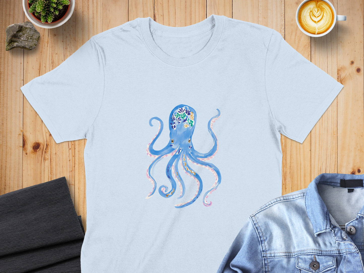Light blue t-shirt with a blue octopus illustration and floral accents.